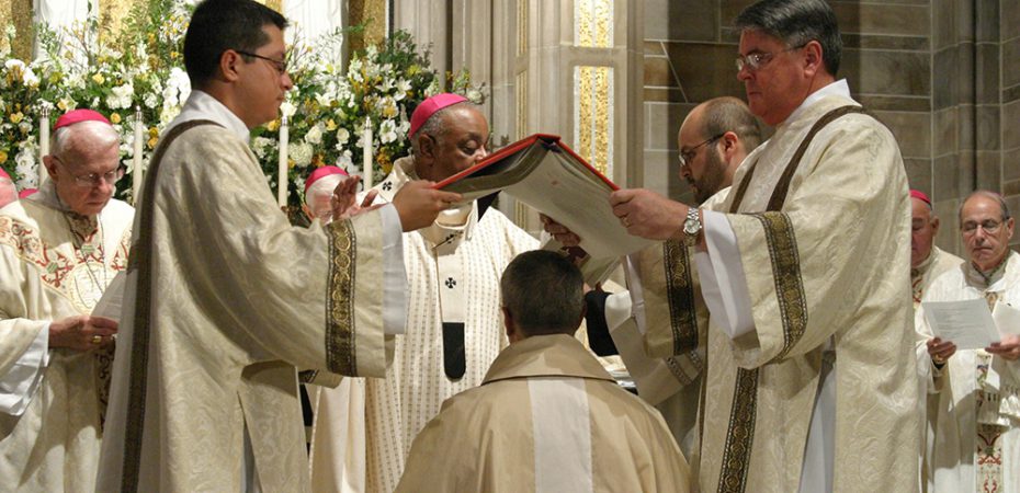DEACONS HOLD BOOK OF GOSPELS OVER HEAD OF ATLANTA AUXILIARY DURING EPISCOPAL ORDINATION